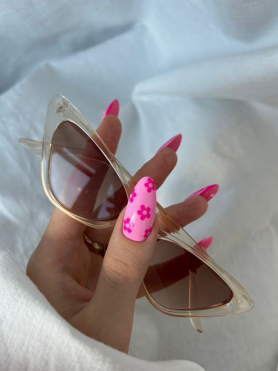 Chic Summer Look: Vibrant Pink Floral Nail Art with Edgy Pointed Shape