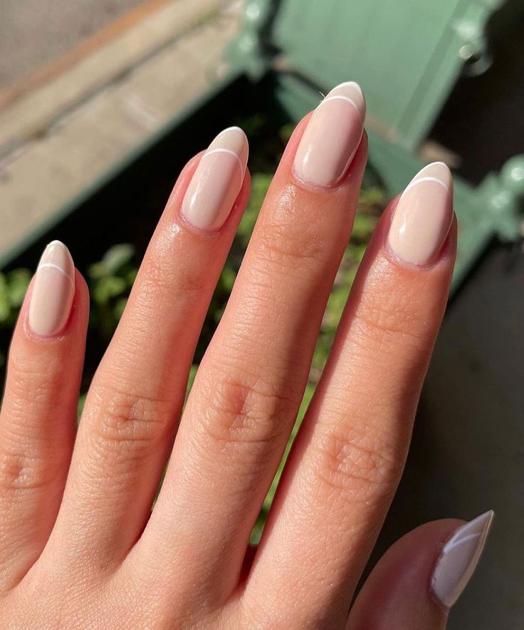 Elegant Chic Nude Nails with Crisp White French Tips for a Minimalist Look.