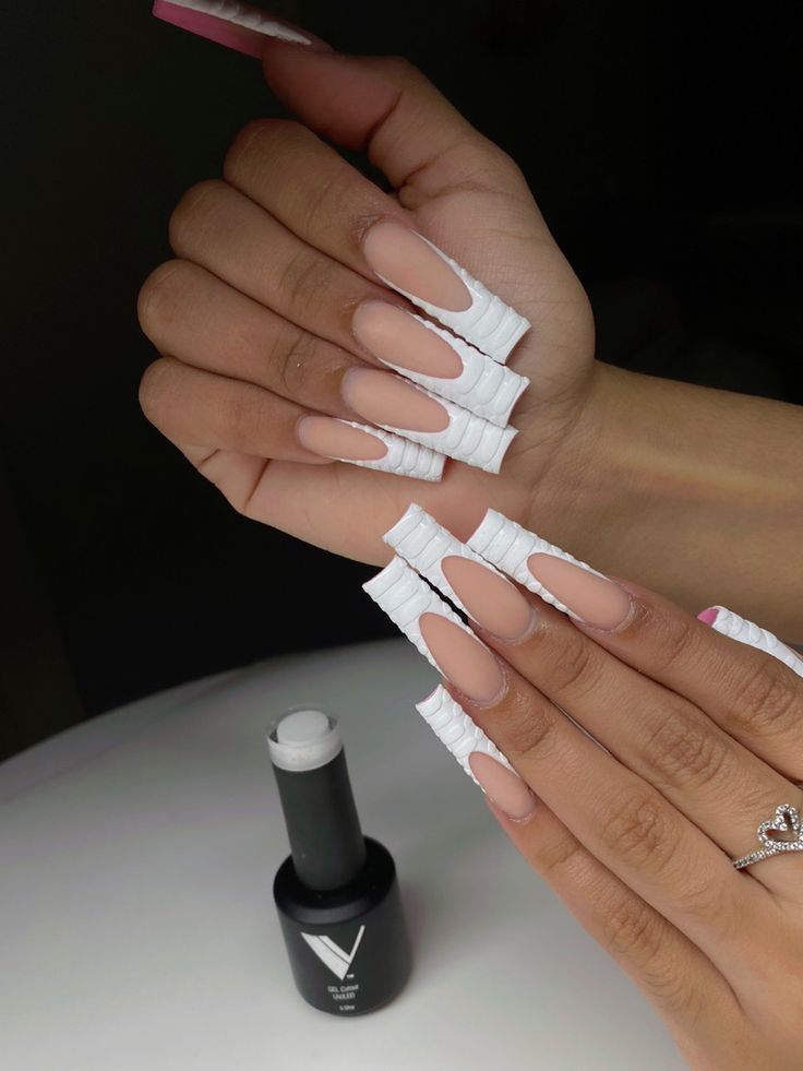 Sophisticated Almond-Shaped Nail Design with Nude Base and White Wraps.