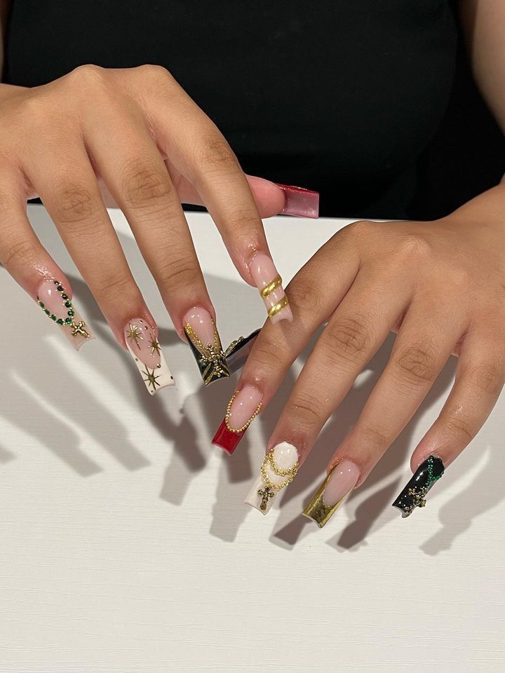 Luxurious Nail Design with Bold Colors and Intricate Embellishments for Special Occasions.
