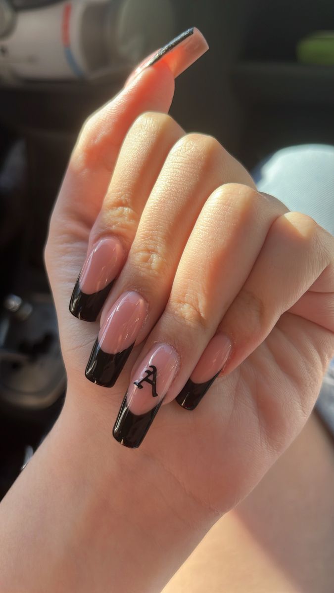 Chic French Tip Nail Design with Bold Black Tips and Personalized Detail.