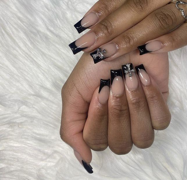 Sophisticated Nude and Black Tip Nail Design with Glamorous Embellishments.