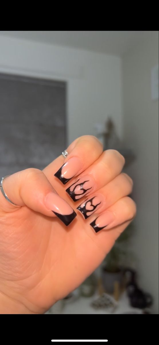 Elegant Nail Design Blending Subtle Nude and Bold Black for Any Occasion