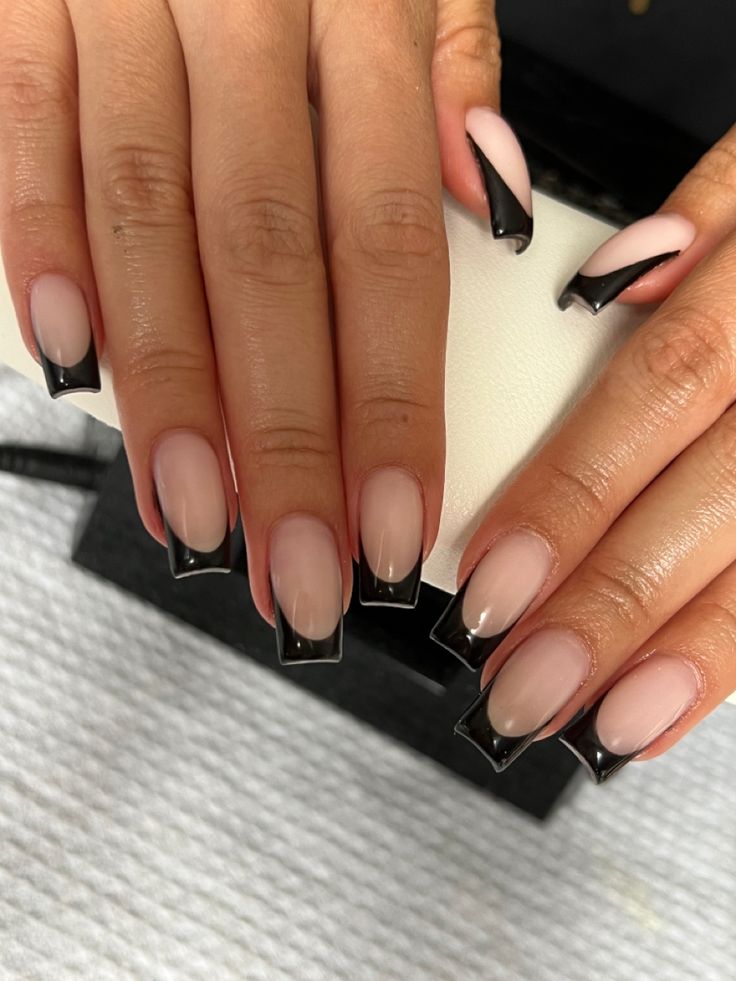 Modern French Manicure: Sophisticated Nude Base with Bold Black Tips.