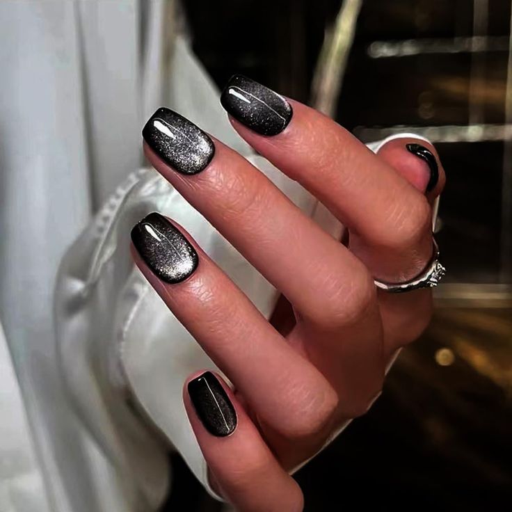 Elegant Sleek Black Nail Design with Glossy Finish and Subtle Shimmer.