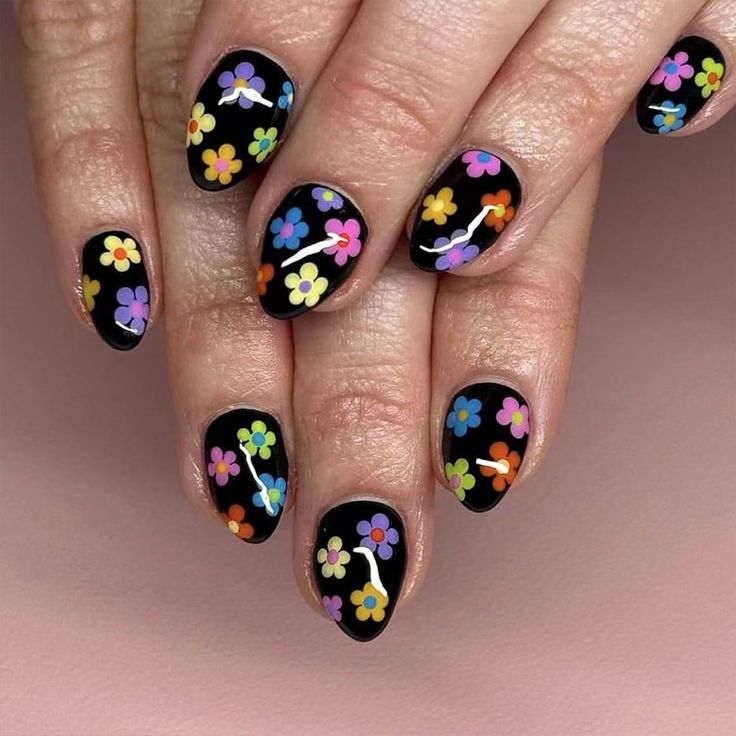 Vibrant Floral Nail Design: Whimsical Blooms on a Sleek Black Background.