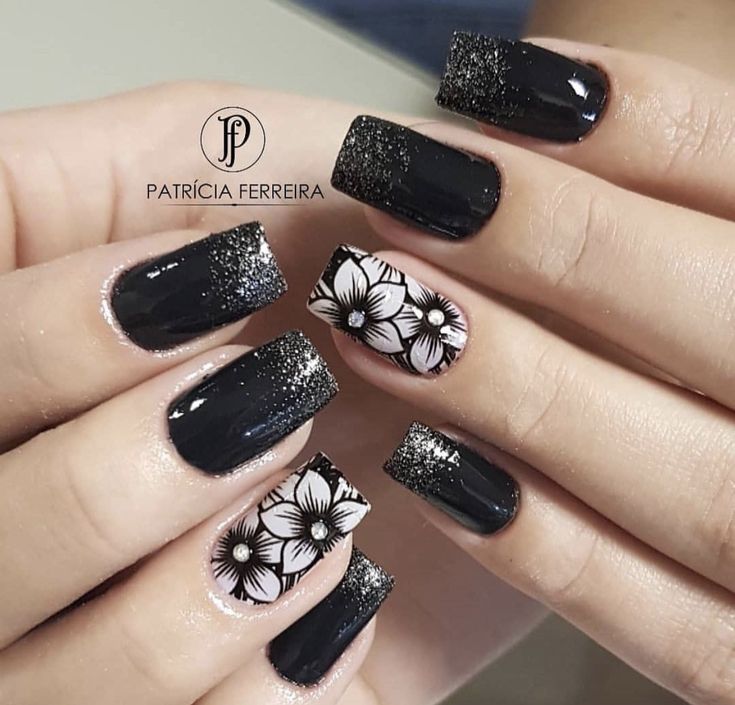 Elegant Dark Black and Glitter Gradient Nail Design with Floral Accents.