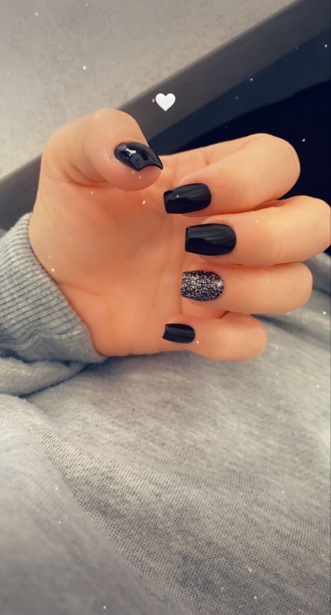 Chic Black Nail Design with Glossy, Textured Finishes and Glitter Accent.