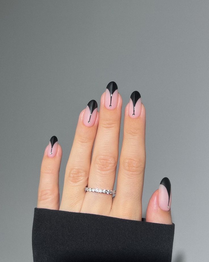 Chic Pink and Black Nail Design with Feminine Silhouette and Artistic Detailing.