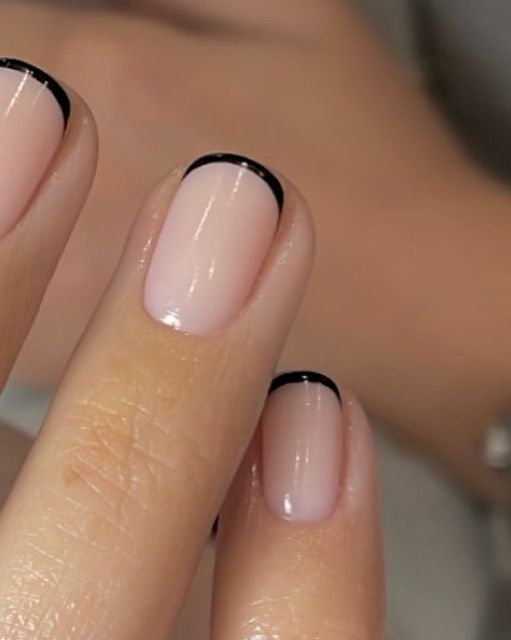 Chic Minimalist Nail Design: Soft Nude Base with Sleek Black Tips