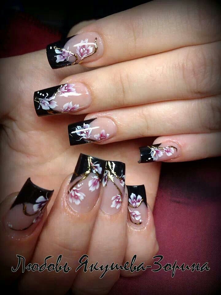 Sophisticated Black-Tipped Nail Design with Delicate Floral Art and Subtle Embellishments.