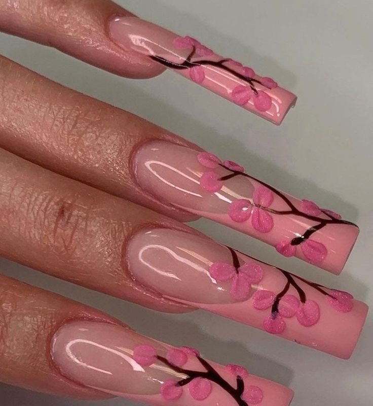 Elegant Cherry Blossom Nail Design: Soft Pink Base with Intricate Black Branches and Vibrant Blossoms.