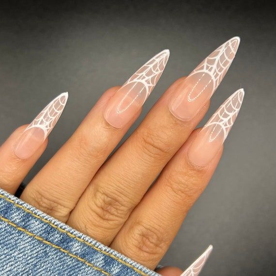 Elegant Chic Stiletto Nails with Intricate White Spiderweb Designs for a Bold Statement.