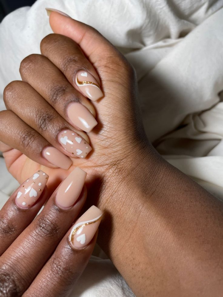 Sophisticated Nail Design: Soft Nudes with Playful Accents and Gold Touches