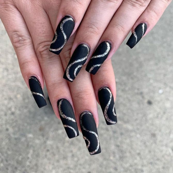 Sophisticated Black Matte Nails with Dynamic Gold Line Art for Bold Statements.