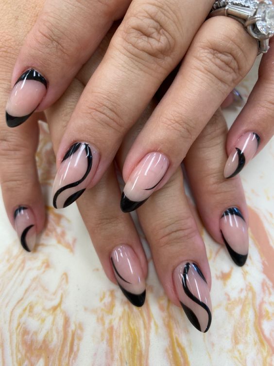 Elegant Nude and Black Nail Design with Stylish Tips and Accents