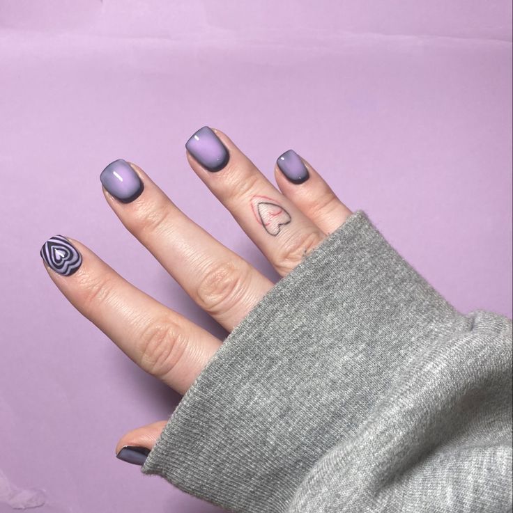 Elegant Lavender Manicure with Playful Designs and Ombre Accent Nails.