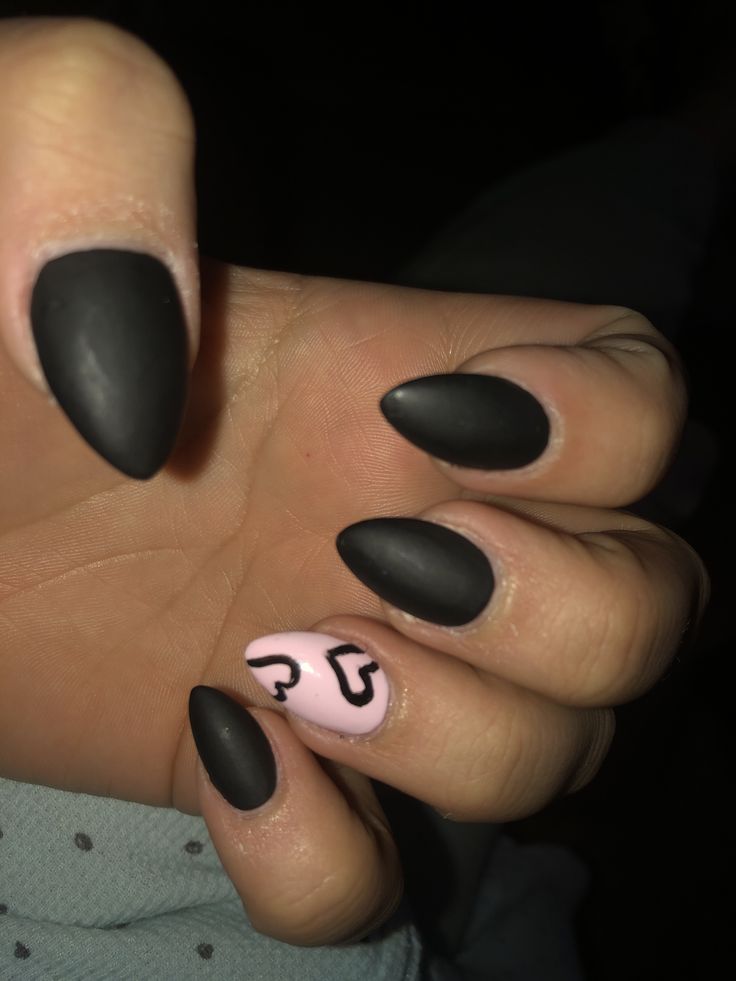 Bold Matte Black and Soft Pink Nail Design with Heart Motif.