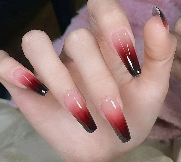 Elegant Stiletto Gradient Nails: Bold Red and Black on a Soft Nude Base