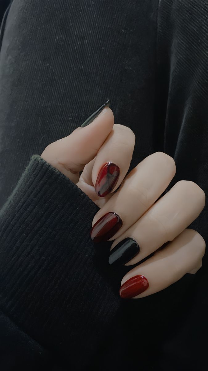 Bold and Modern Deep Red and Black Marbled Nail Design.