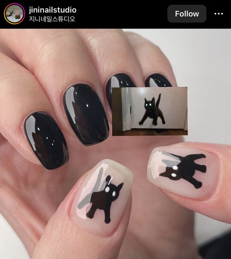 Whimsical Elegance: Glossy Black and Soft Nude Nail Design with Playful Cat Motifs