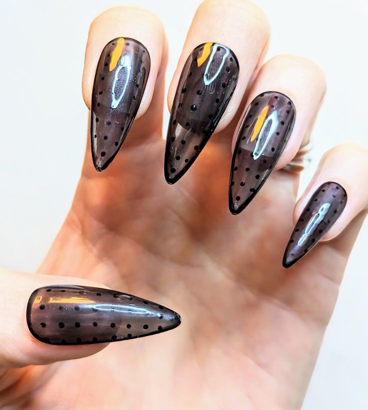 Striking Elegant Nails with Dark Sheer Finish and Polka Dots for a Modern Statement.