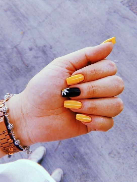 Chic Yellow and Black Manicure: A Bold, Artistic Statement.