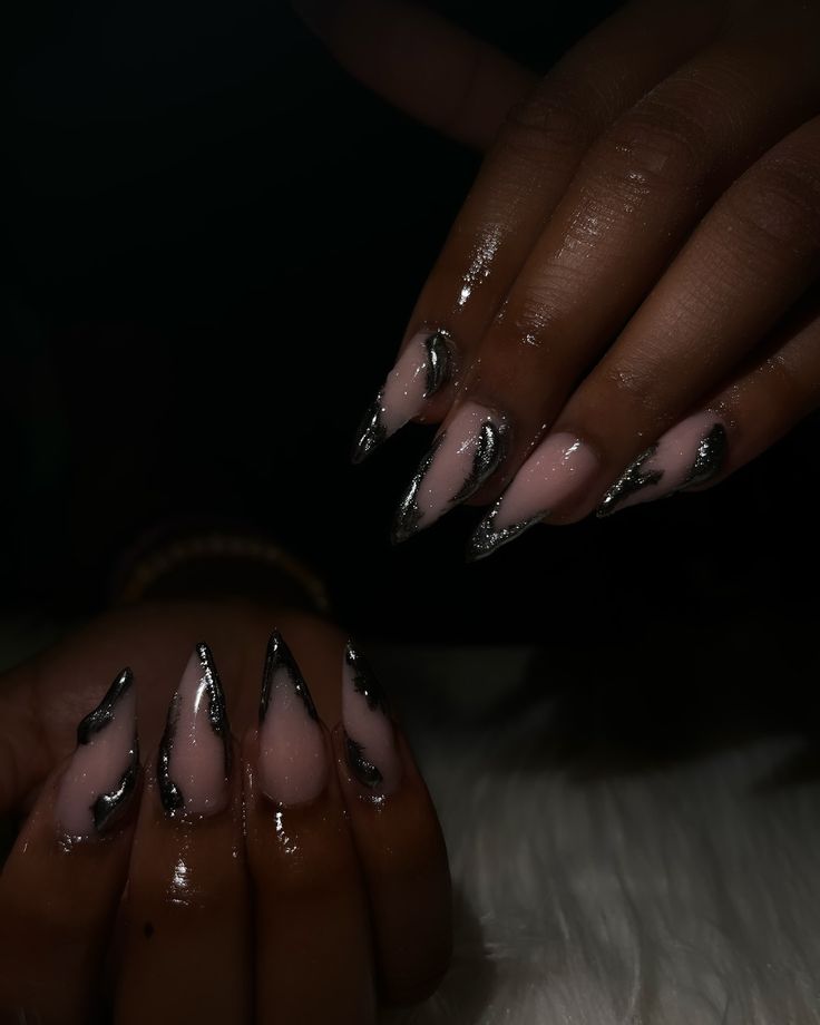 Chic Nail Art: Elegant Nude and Shimmering Black Design with Dramatic Elongated Tips