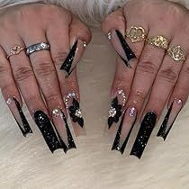 Bold Black Stiletto Nail Design with Elegant Sparkling Accents and Intricate Bows