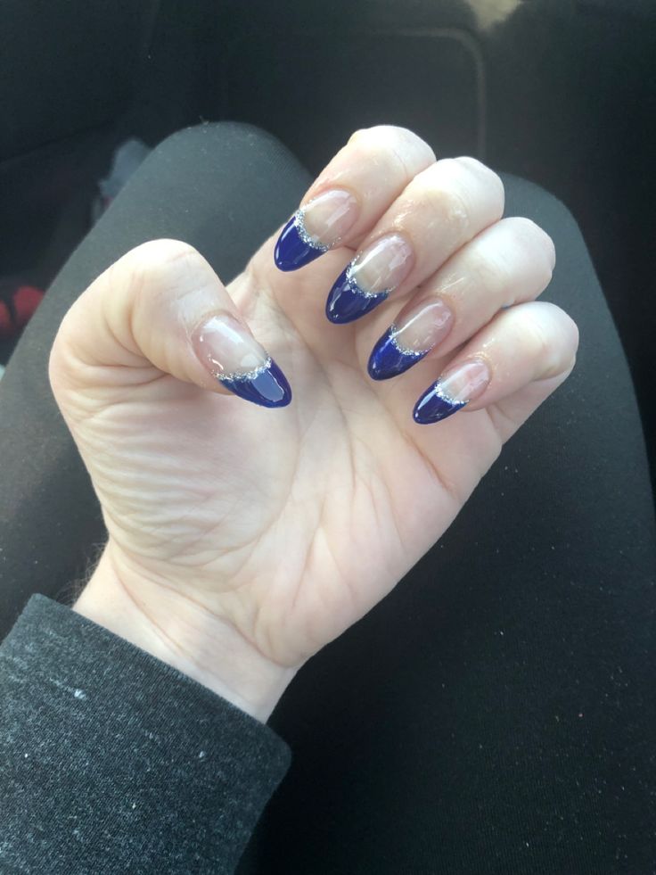 Sophisticated Deep Blue French Tip Manicure with Delicate Silver Accents.