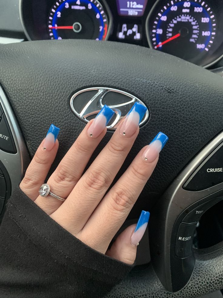 Elegant Gradient Nail Design with Vibrant Blue Tips and Gem Accents