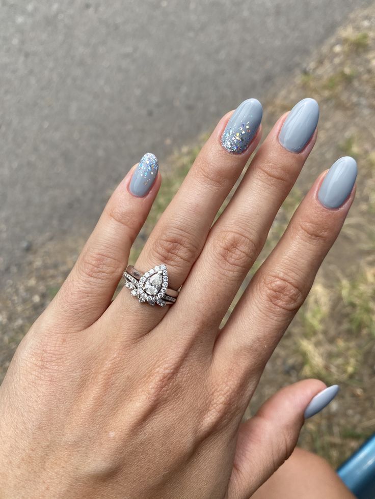 Chic Gray and Blue Ombre Nail Design with Silver Rings for a Sophisticated Look.