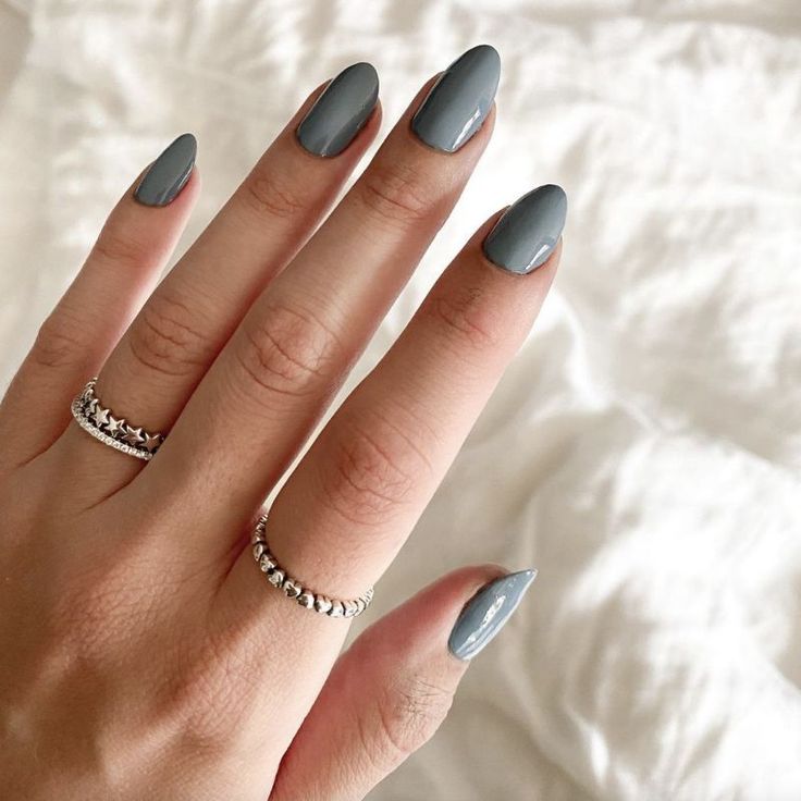 Sophisticated Almond-Shaped Nails in Chic Gray with Modern Shine and Delicate Ring Accents.