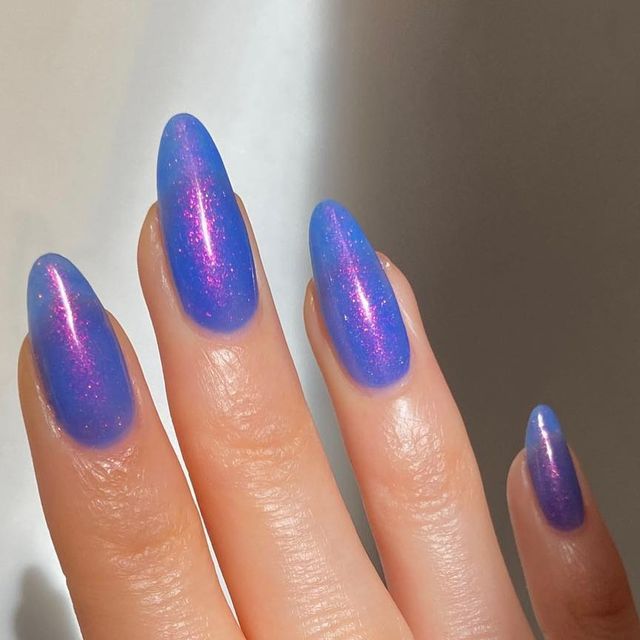 Mesmerizing Ombre Holographic Nails in Vibrant Blue and Purple with Glamorous Almond Elegance.