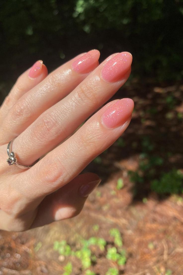 Elegant Almond-Shaped Nail Design: Soft Pink with Subtle Shimmer for Any Occasion.