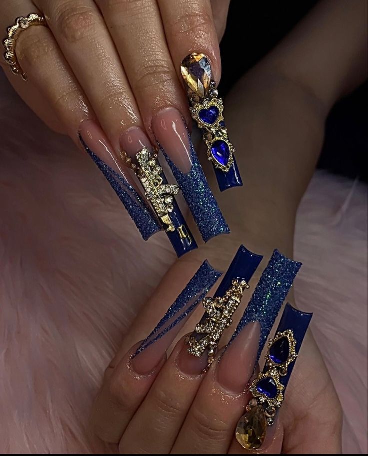 Elegant Stiletto Nail Design with Intricate Embellishments and Striking Ombre Effect