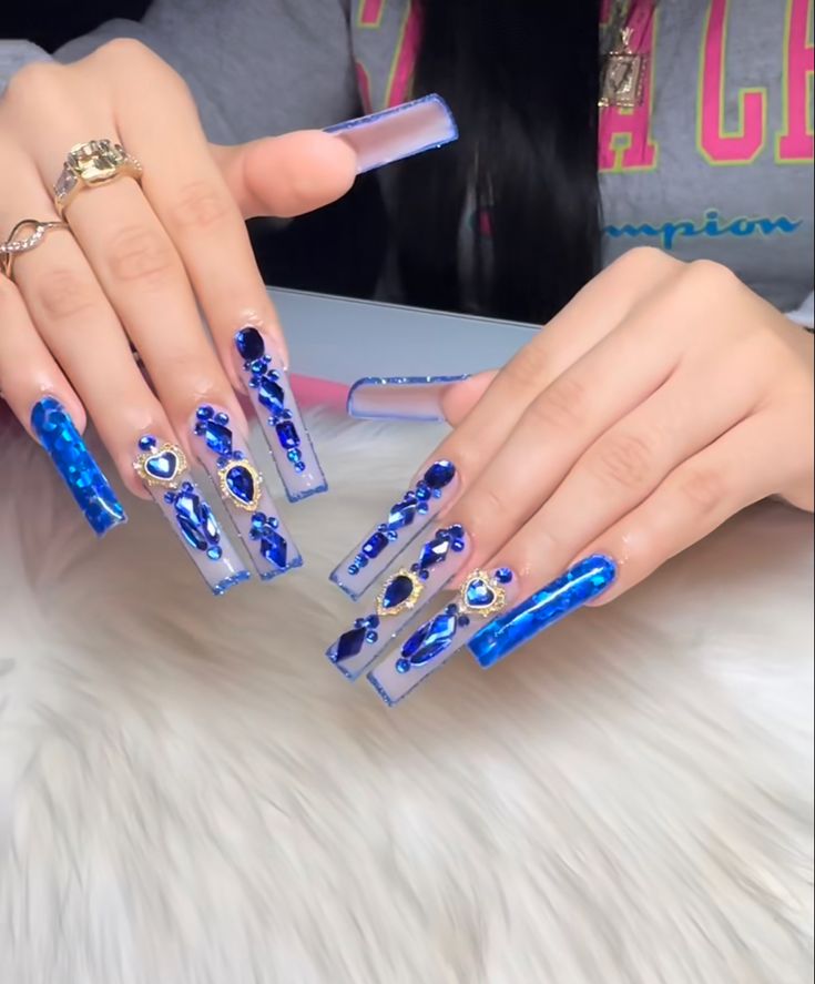 Glamorous Blue-Themed Nail Design with Gemstone Accents and Textured Finishes.