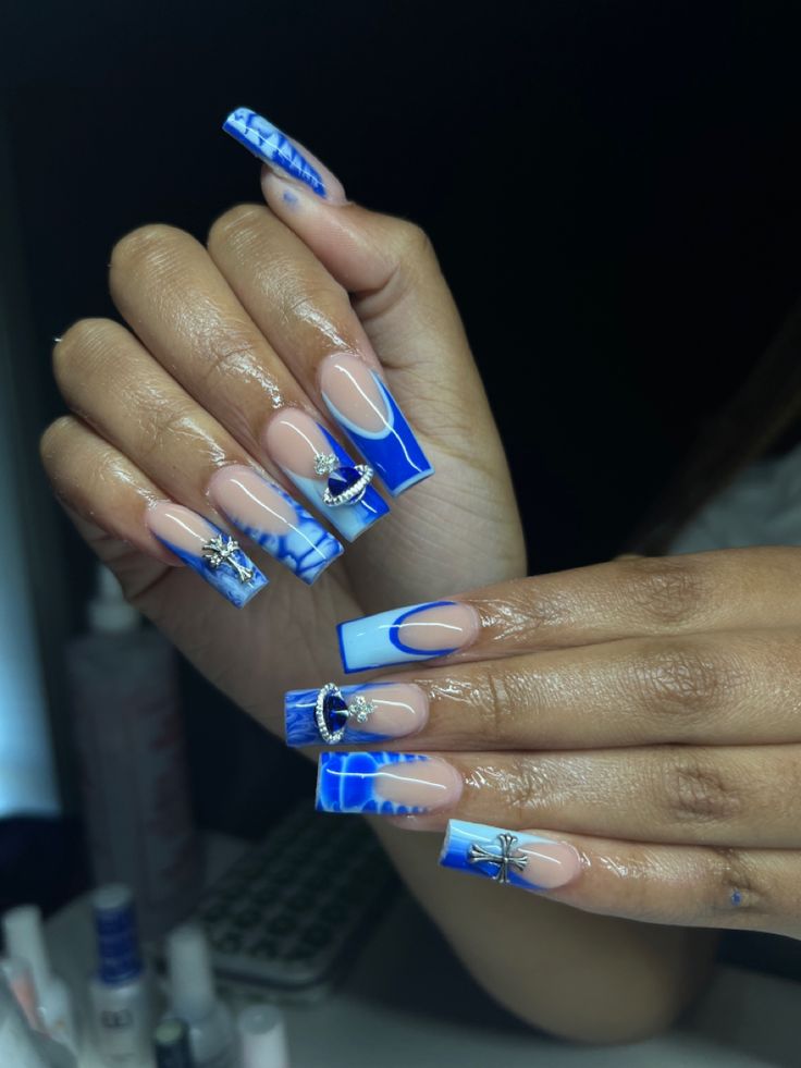 Stunning Blue Ombre Nail Design with Glam Silver Charms on Trendy Long Square Tips.