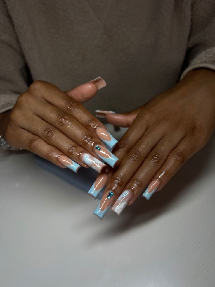 Trendy Pastel Blue and Nude Long Nails with Elegant Marbling and Gem Accents