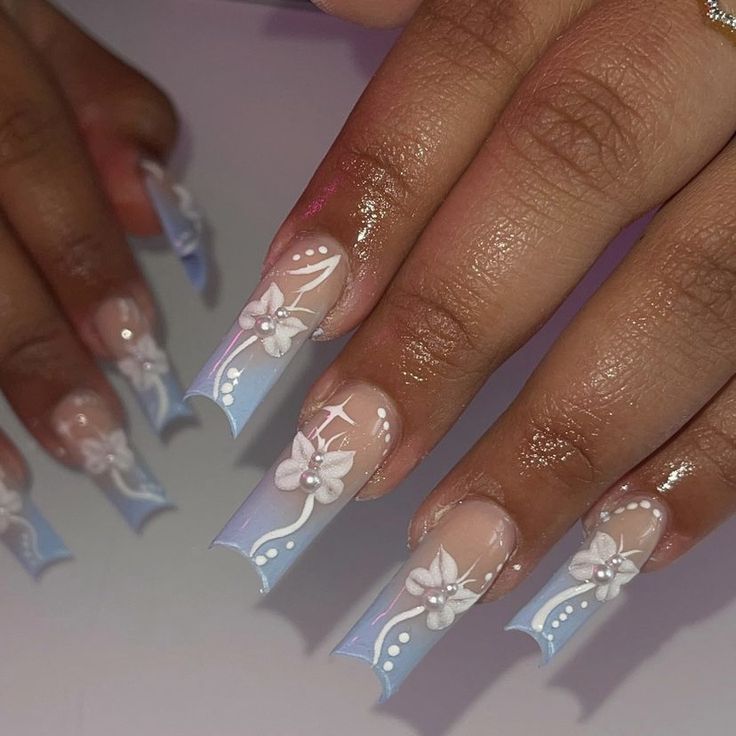 Elegant Floral Ombre Nail Design with Soft Blue and Nude Gradients.