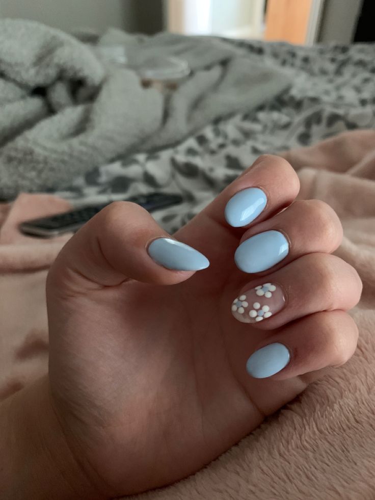 Elegant Pastel Blue Nail Art with Floral Accent for Chic Style