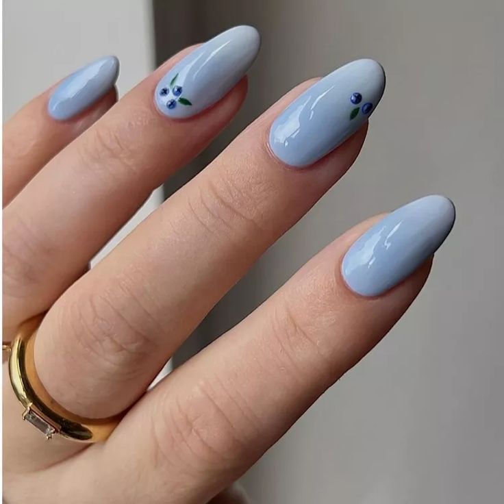 Elegant Soft Blue Nails with Glossy Finish and Whimsical Floral Accents.