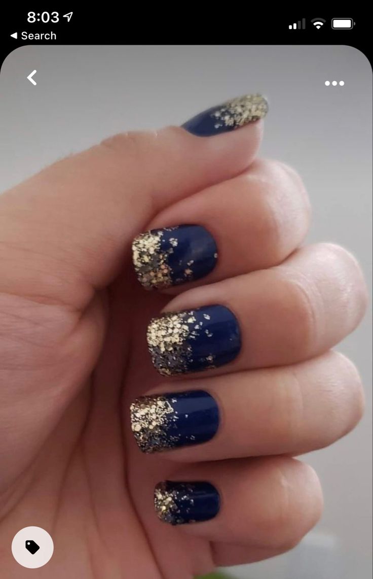 Stunning Gradient Navy Blue Nail Design with Gold Glitter Tips for Glamorous Occasions.