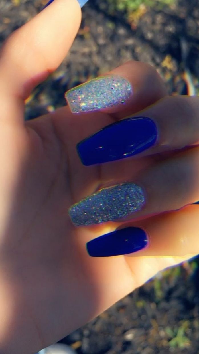 Bold Deep Blue Nail Design with Elegant Glitter Accents.