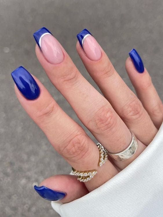 Chic Vibrant Nail Design: Striking Blue with Soft Pink Accents and Bold Square Shape.