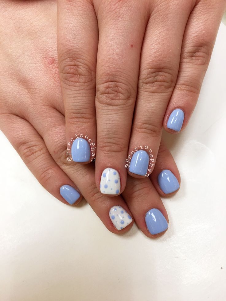 Chic Soft Blue Nail Design: Elegant Simplicity Meets Playful Accents.