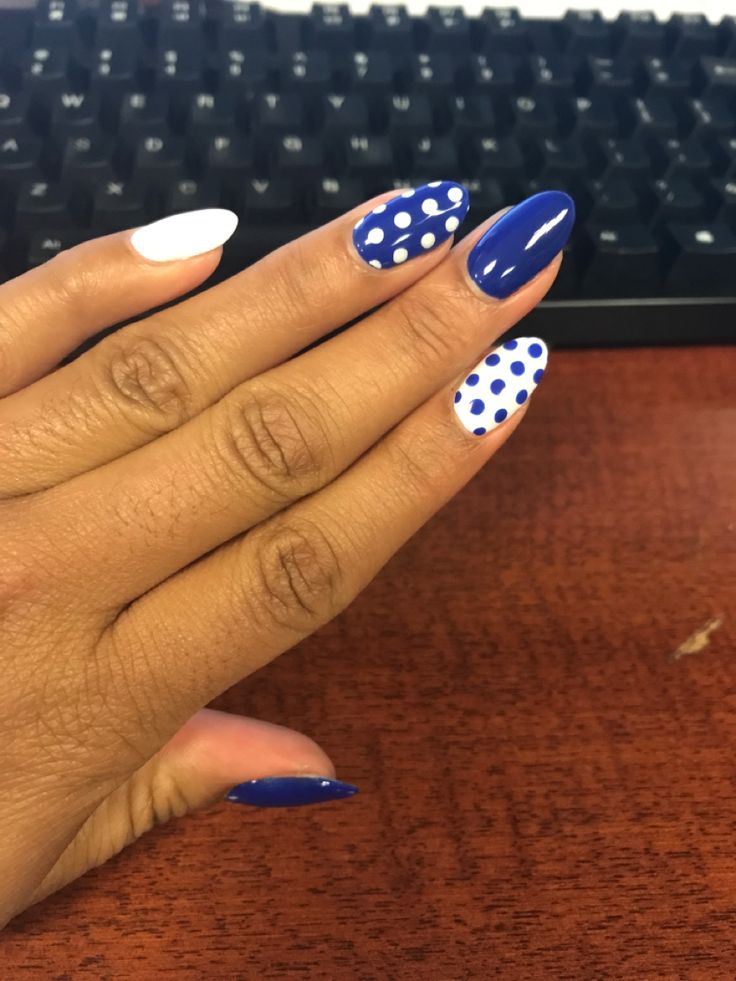 Playful Nail Design with Striking Blue and White Polka Dots