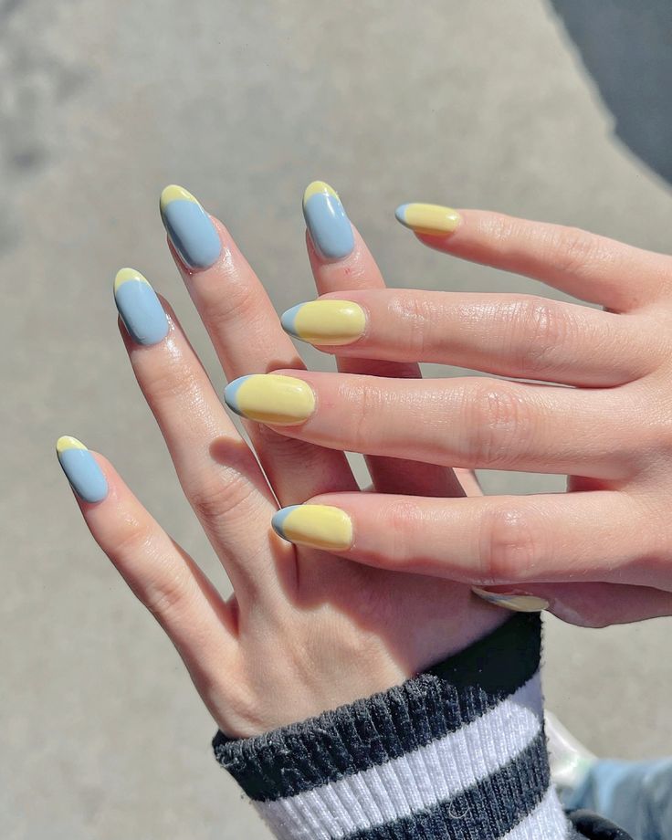 Charming Pastel Nail Design: Soft Blue and Yellow French Tips for a Playful Spring Look.