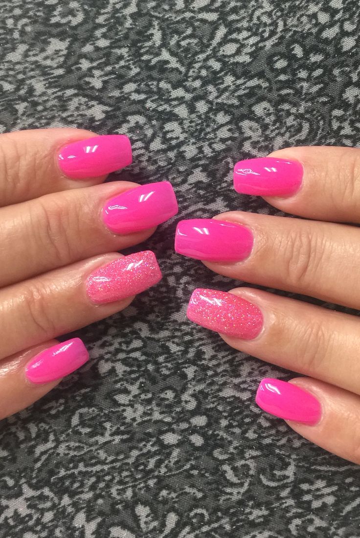 Vibrant Pink Glossy Nails with Playful Glitter Accents for a Cheerful Aesthetic.