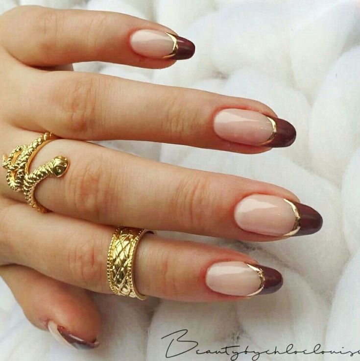 Sophisticated Neutral and Deep Burgundy French Tip Nail Design with Gold Accents.